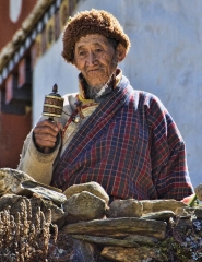 old man with prayer wheel